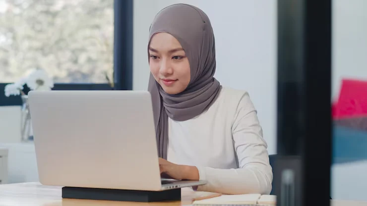 An adult learner at her laptop
